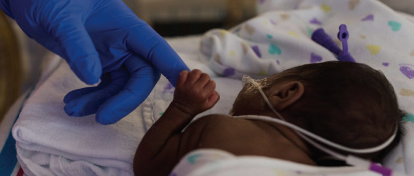 NICU baby holding a parent's finger