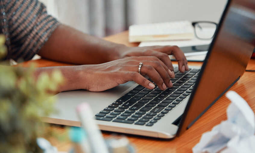 Womany typing on a computer | ICU baby's Forum Volunteer Position